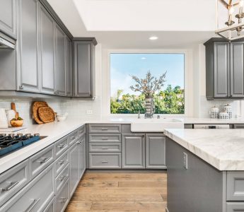 A modern marble kitchen with sleek gray cabinets